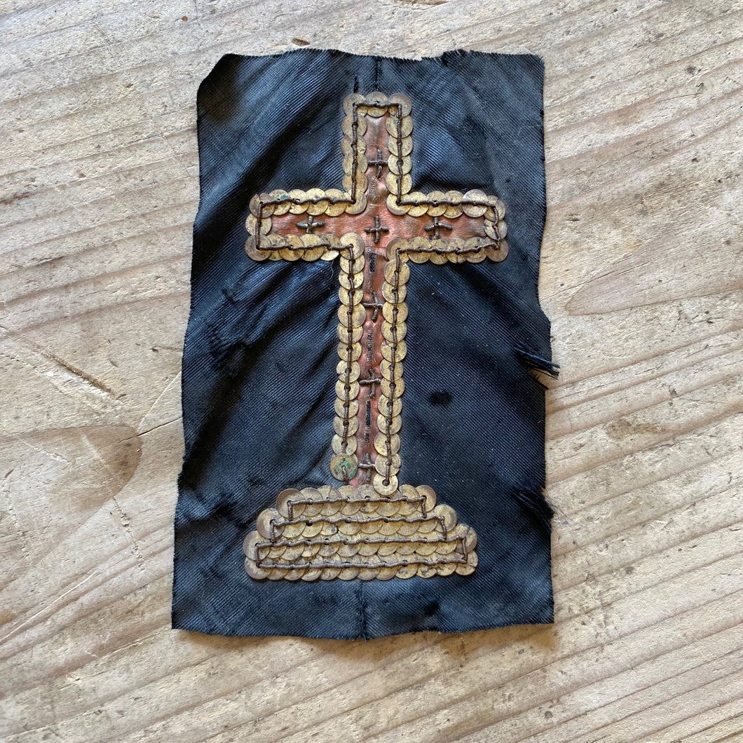 Sequined crucifix on fabric