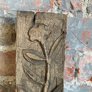 Carved wooden panel: floral stem
