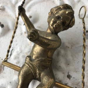 Bronze cherub/putti on swing