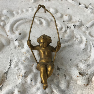 Small bronze cherub/putti on swing